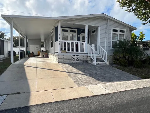 a view of a house with more windows and flower plants