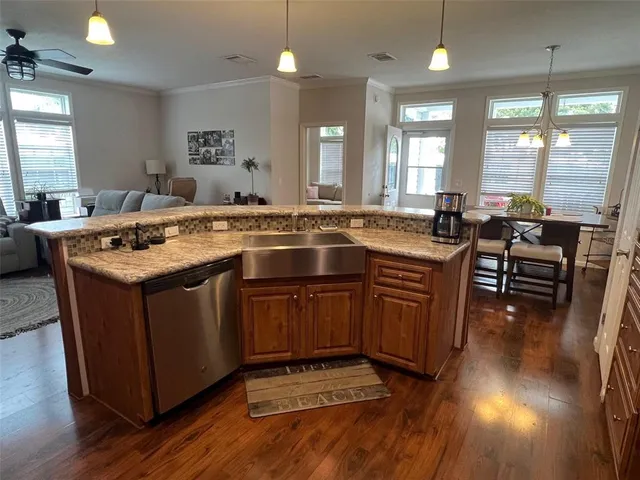 a kitchen with stainless steel appliances granite countertop a stove a sink and a refrigerator