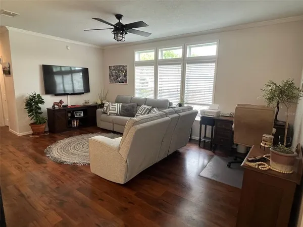 a living room with furniture window and a flat screen tv