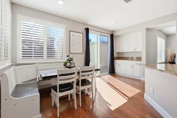 a dining room with furniture and wooden floor