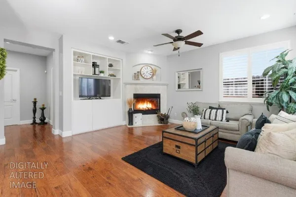a living room with furniture fireplace and window