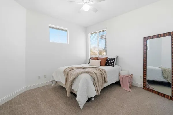 a bedroom with bed and a window