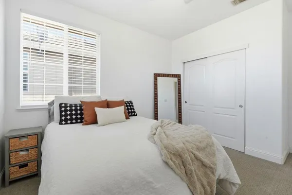 a bedroom with a bed and a window