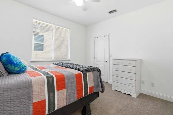 a bedroom with a bed and a dresser