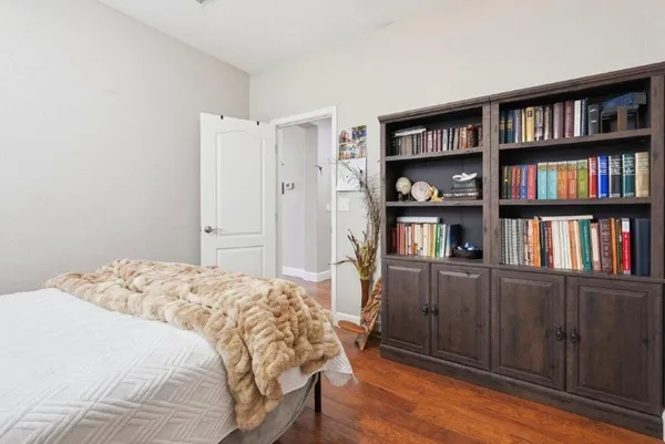 a bedroom with a bed and a book shelf