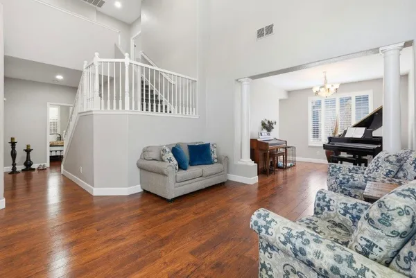 a living room with furniture and a wooden floor