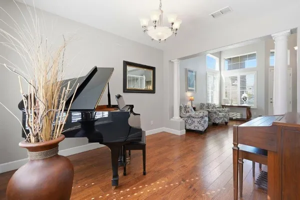 a living room with furniture and a chandelier