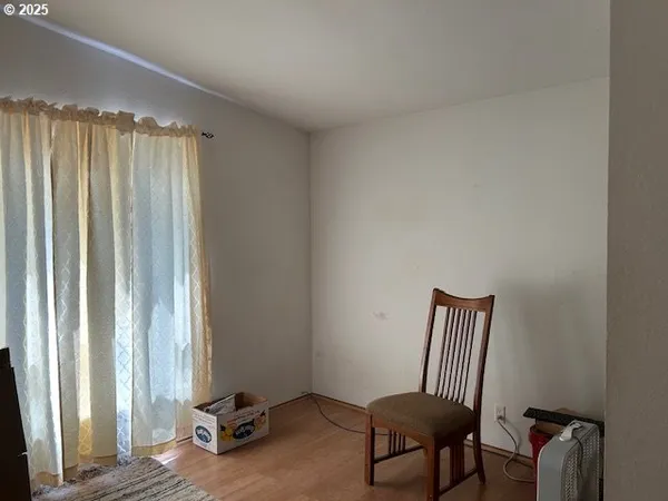 a view of a room with a window and a chair