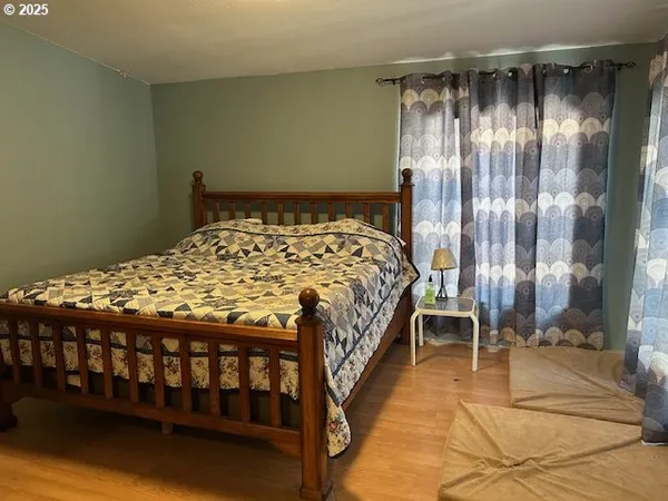 a bedroom with a bed and a mirror