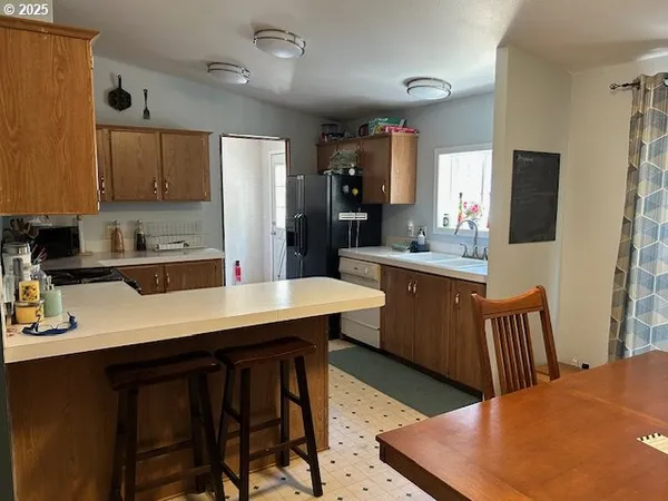 a kitchen with a sink a counter top space and stainless steel appliances