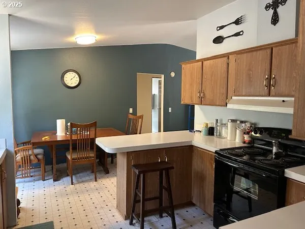 a kitchen with a sink cabinets and stove