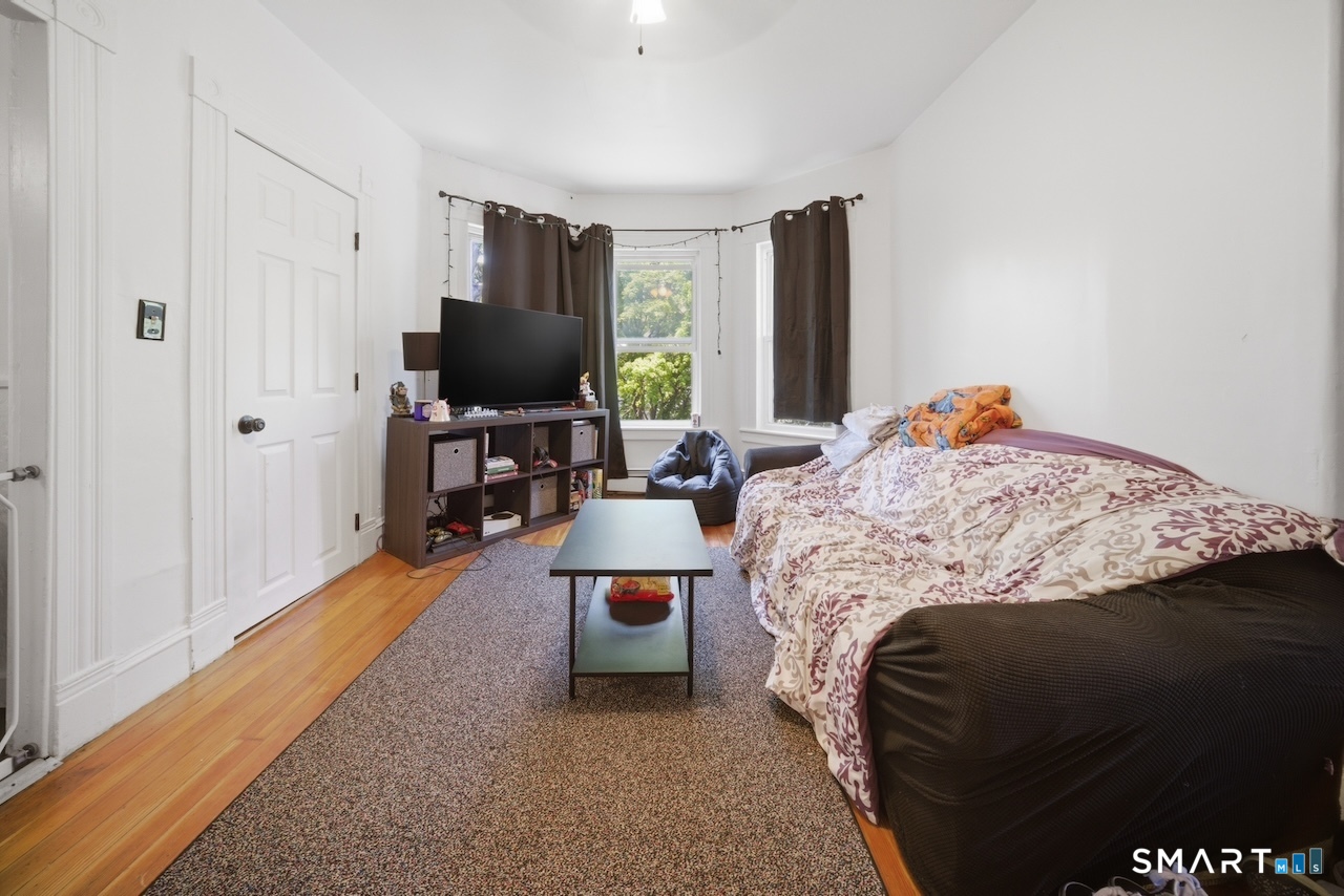 12 Webster Street Vernon, CT 06066 - Photo 13 of 33 a bedroom with a bed and a flat tv screen
