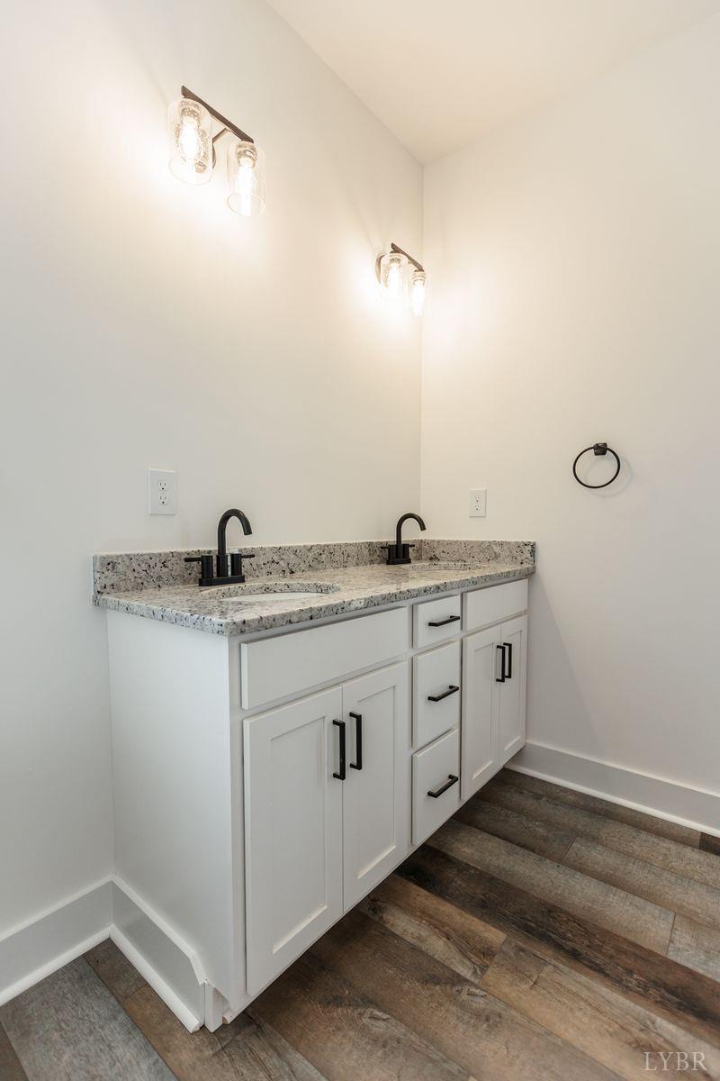 9740 Oakville Road Gladstone, VA 24553 - Photo 46 of 75 a bathroom with a granite countertop sink and white cabinets