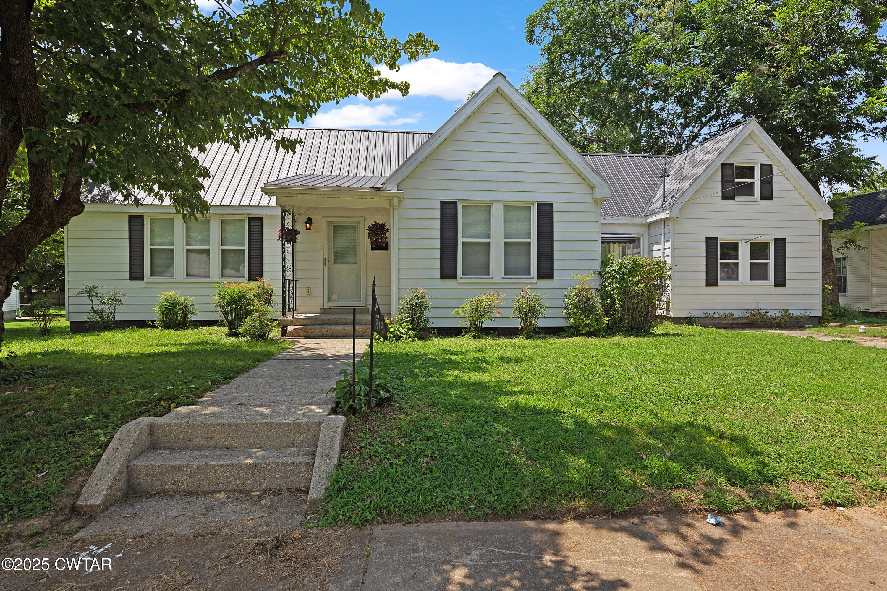 a front view of a house with a yard and porch