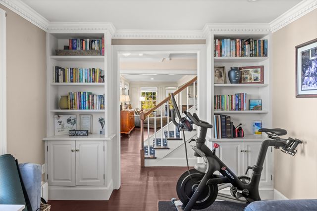 a view of a workspace with furniture and a bookshelf