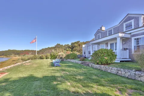 a view of a house with a yard and a garden