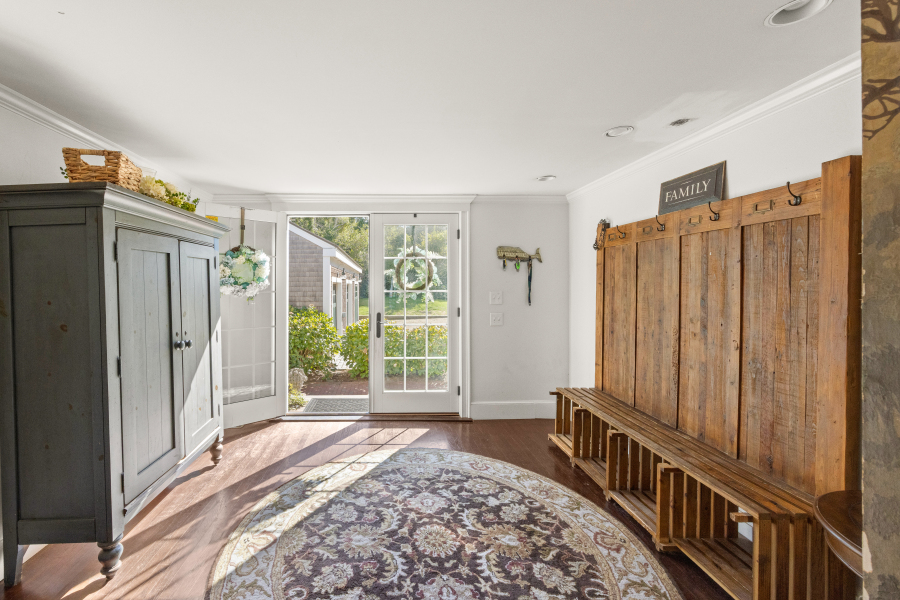 9 Fowler Avenue Edgartown, MA 02539 - Photo 6 of 27 a view of a hallway with windows and stairs