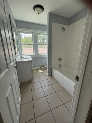 a bed room with a bed and a window