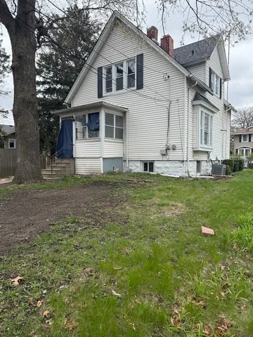 a view of a house with a yard covered in snow