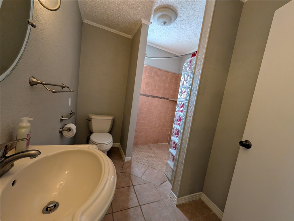 4621 Constance Street Corpus Christi, TX 78413 - Photo 13 of 19 a bathroom with a sink and mirror with toilet