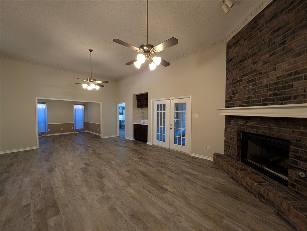 4621 Constance Street Corpus Christi, TX 78413 - Photo 5 of 19 a view of a livingroom with a fireplace a ceiling fan a fireplace and windows