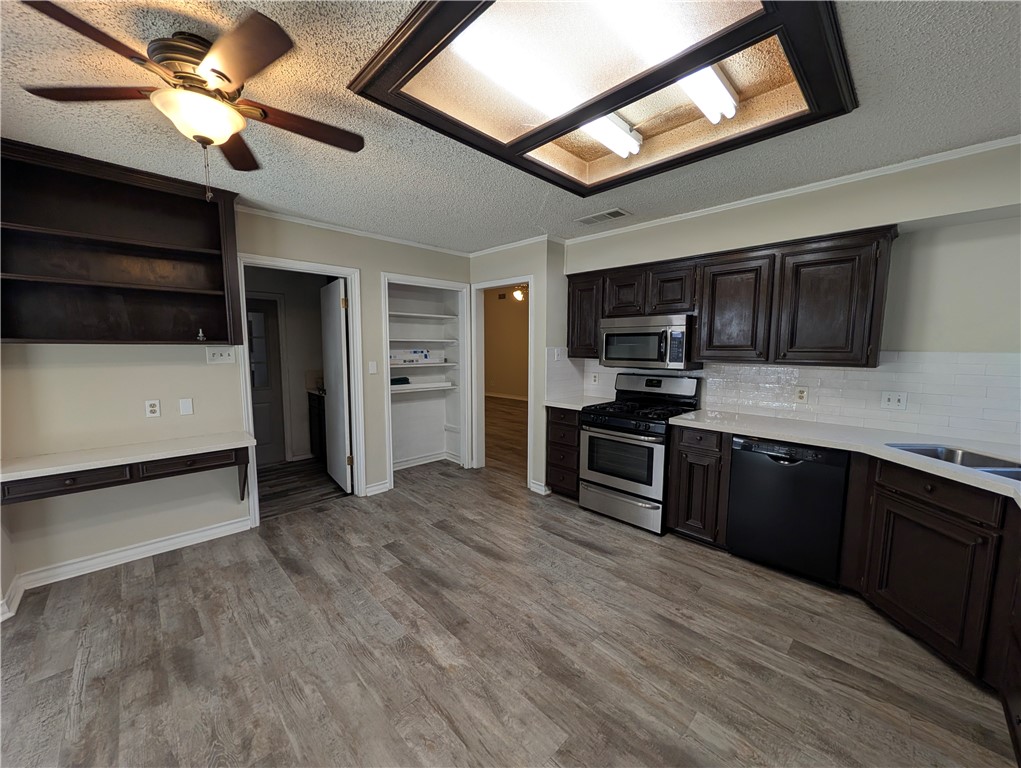 4621 Constance Street Corpus Christi, TX 78413 - Photo 7 of 19 a kitchen with stainless steel appliances granite countertop a stove and a refrigerator
