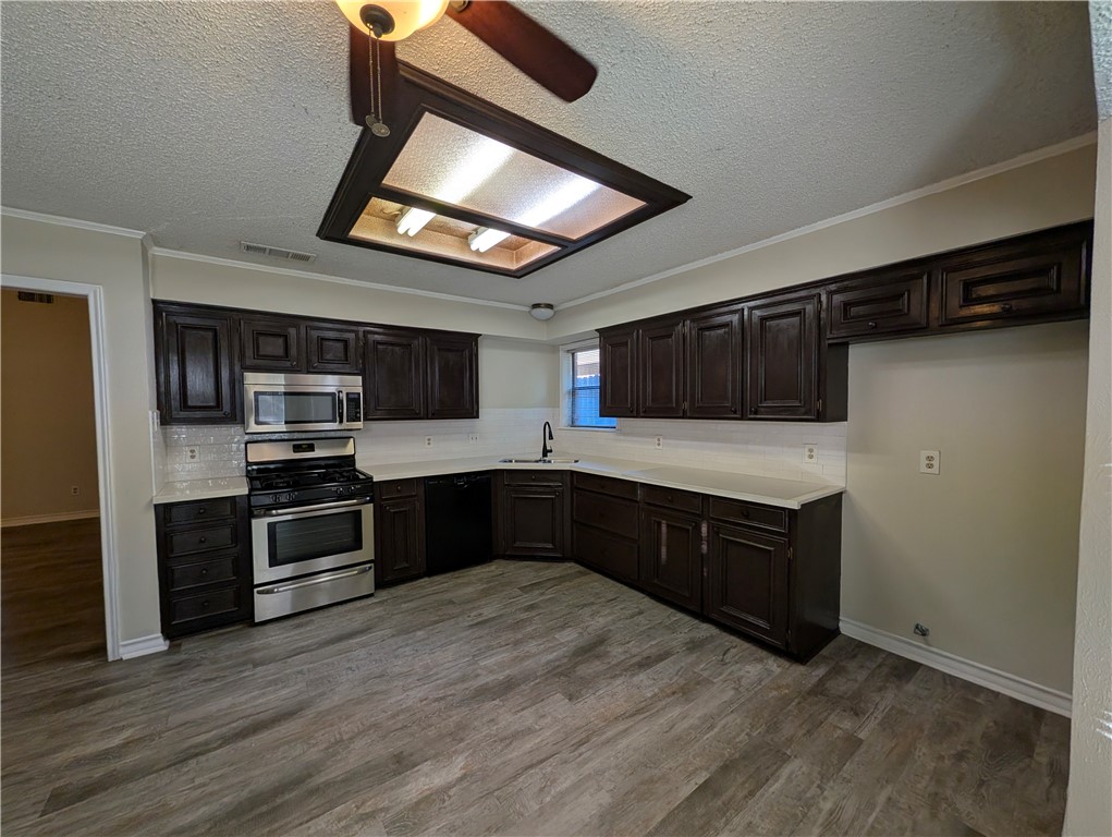 4621 Constance Street Corpus Christi, TX 78413 - Photo 9 of 19 a kitchen with stainless steel appliances granite countertop a stove and a microwave