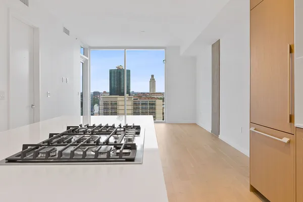 a kitchen with wooden cabinets and a stove