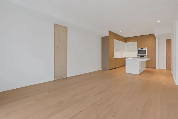 a view of a kitchen with a sink and a refrigerator