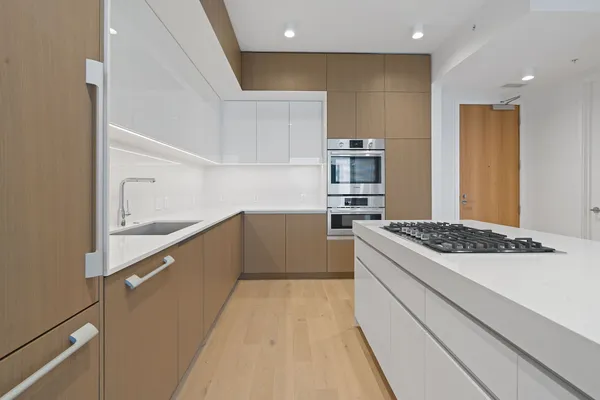 a kitchen with stainless steel appliances granite countertop a stove and a refrigerator