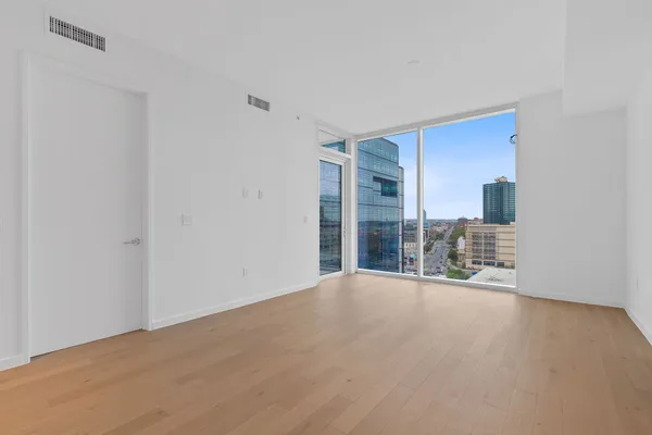 a view of a big room with windows and chandelier
