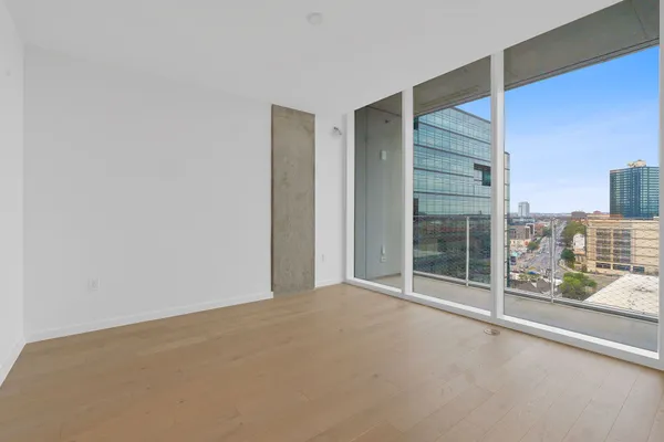 a view of an empty room with glass door