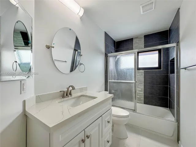 a bathroom with a toilet sink and shower