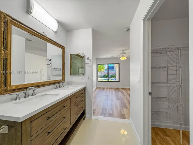 a bathroom with a sink a light fixture and a mirror