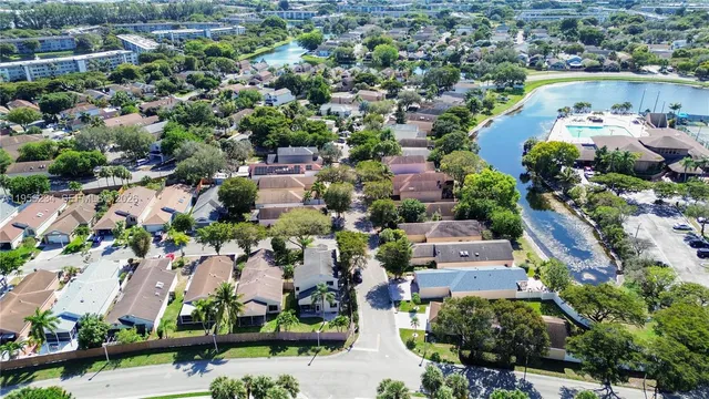 an aerial view of residential houses with outdoor space and lake view