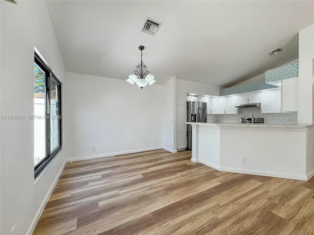a view of a kitchen with an empty space and a window