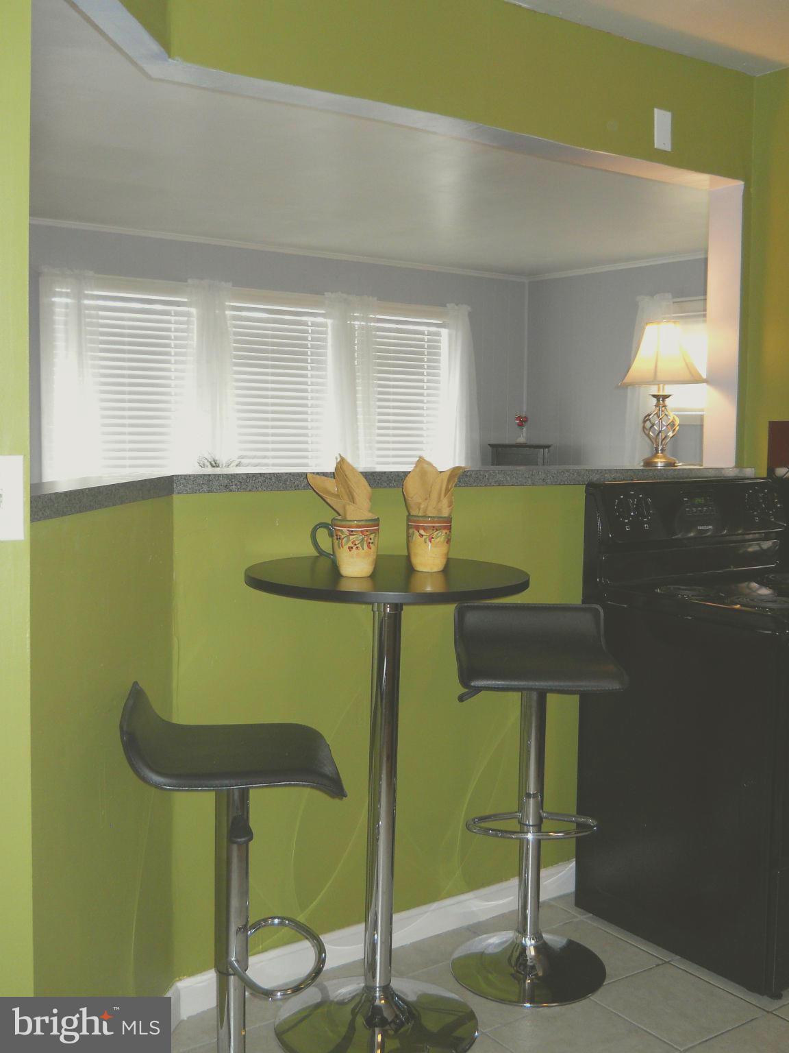 7411 Sudbrook Road Baltimore, MD 21208 - Photo 13 of 30 a view of kitchen island with chair and table