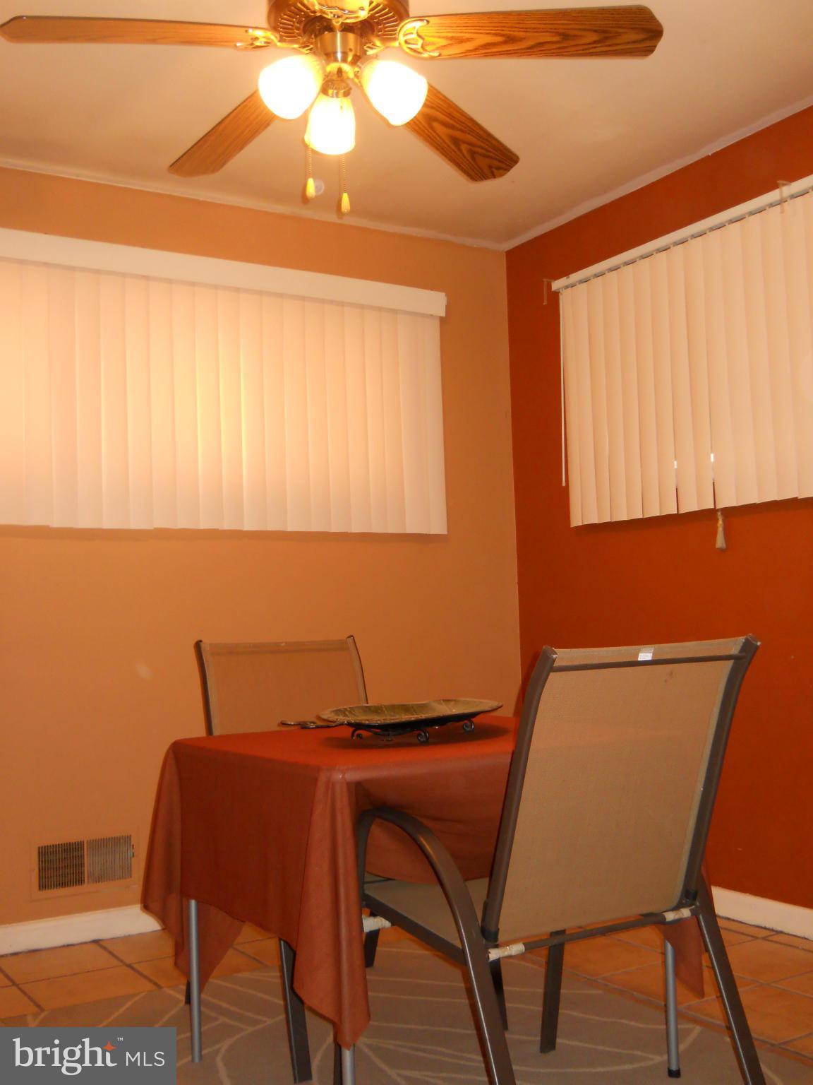 7411 Sudbrook Road Baltimore, MD 21208 - Photo 17 of 30 a view of a dining room with furniture and wooden floor