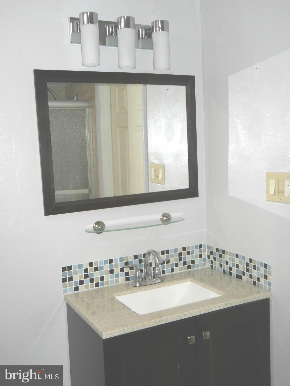 7411 Sudbrook Road Baltimore, MD 21208 - Photo 18 of 30 a bathroom with a sink and a mirror
