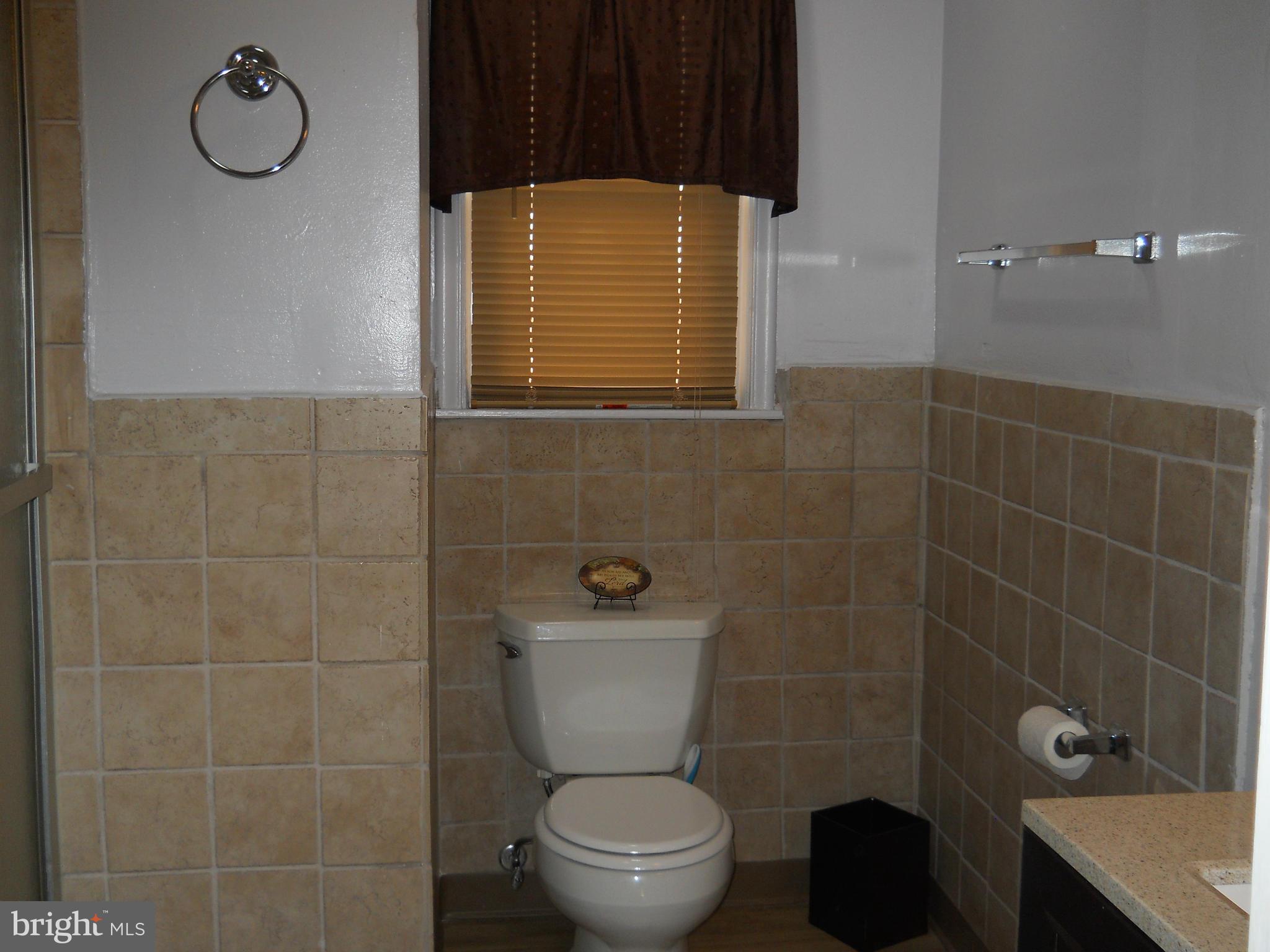 7411 Sudbrook Road Baltimore, MD 21208 - Photo 20 of 30 a bathroom with a toilet and a shower