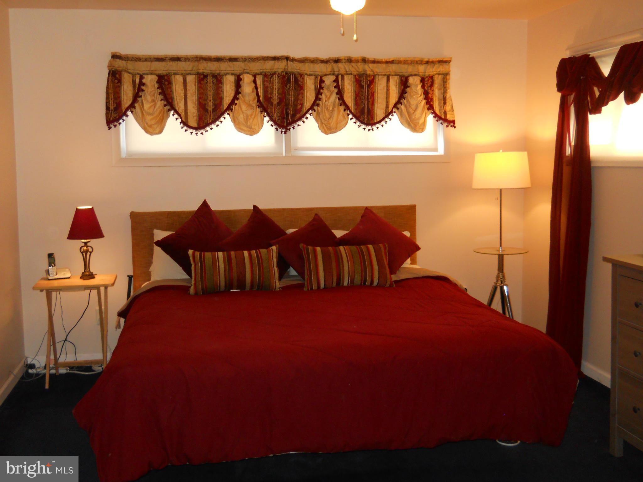 7411 Sudbrook Road Baltimore, MD 21208 - Photo 22 of 30 a bedroom with a bed and window