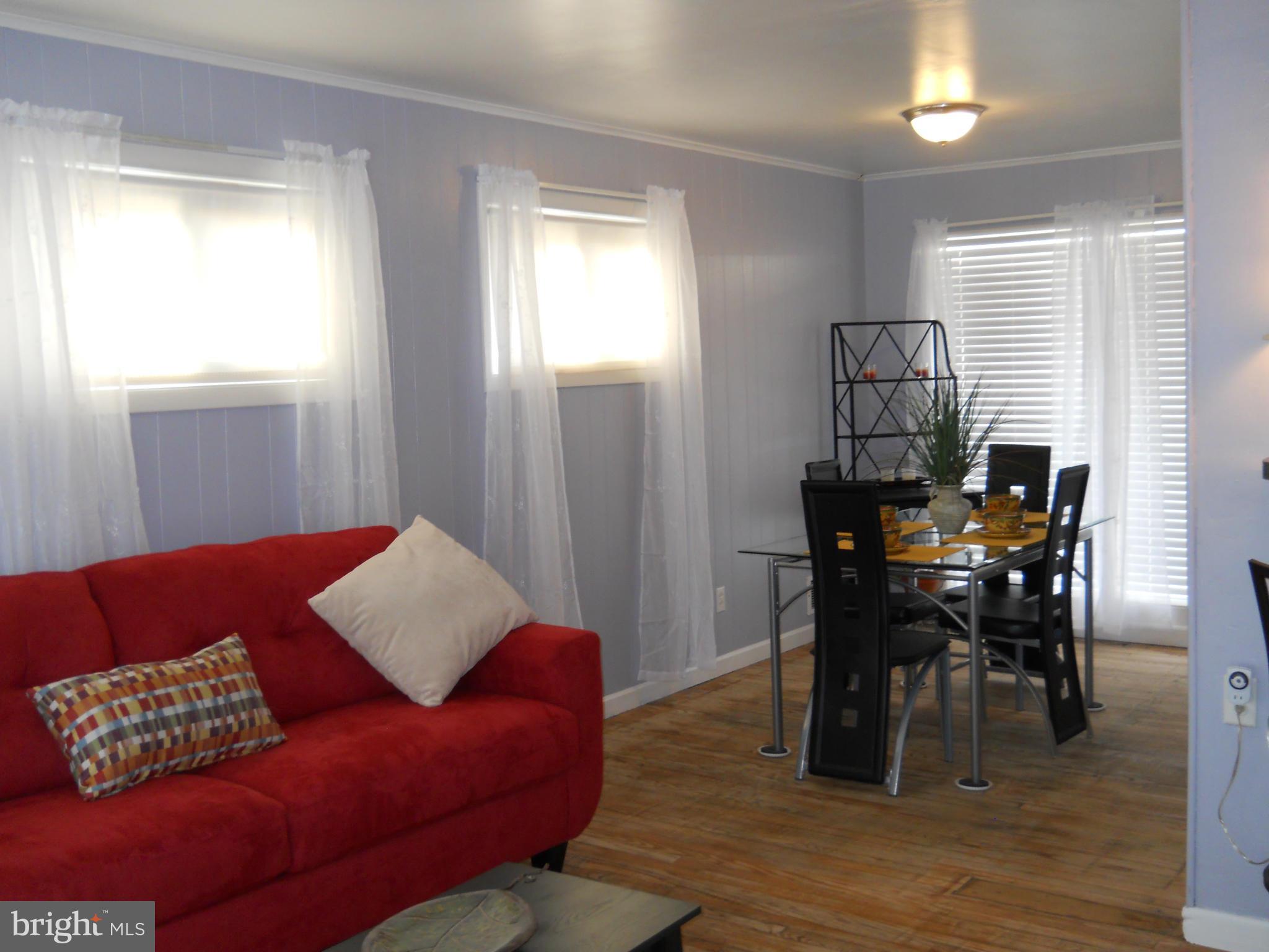 7411 Sudbrook Road Baltimore, MD 21208 - Photo 6 of 30 a living room with furniture and a window