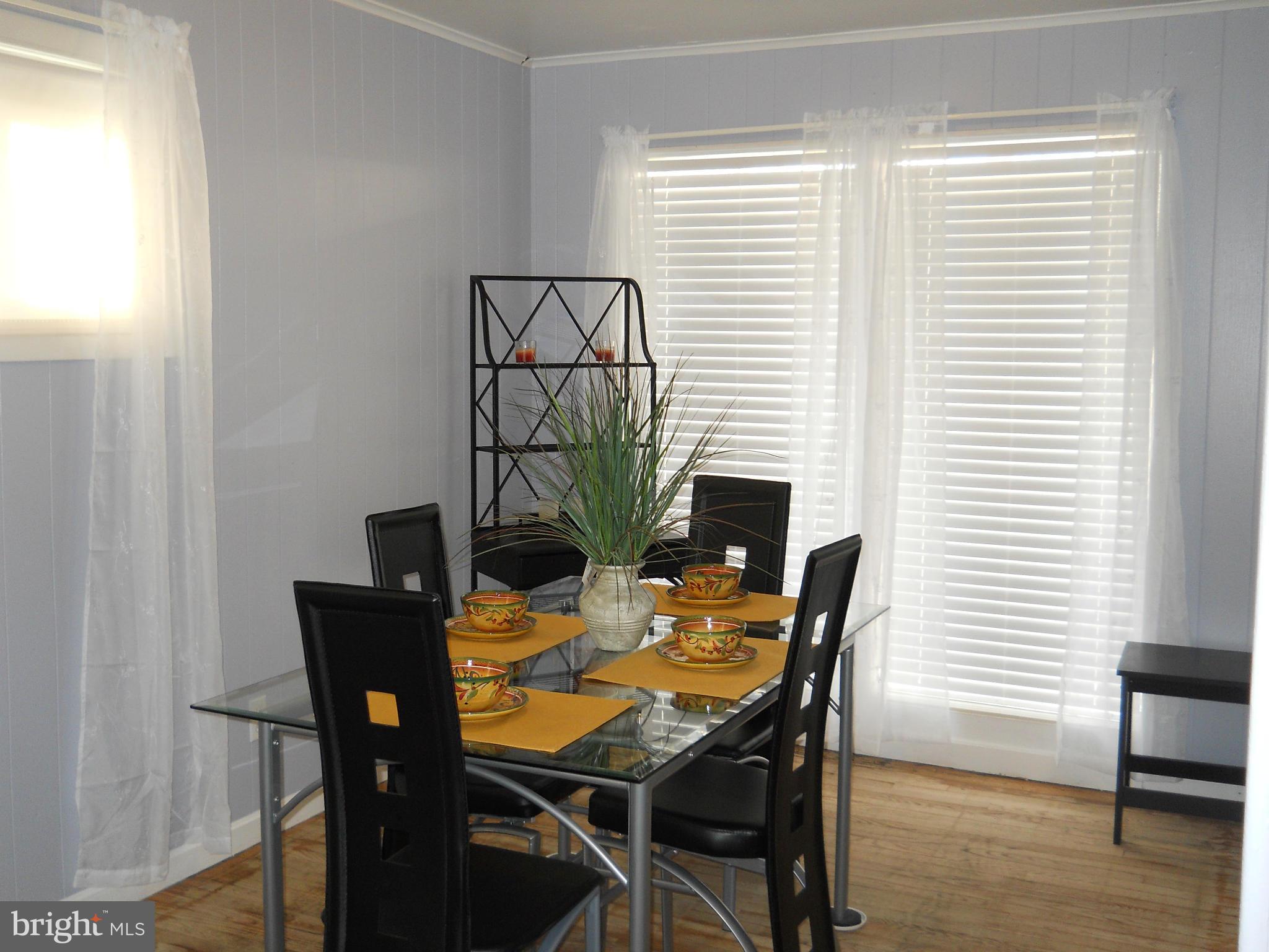 7411 Sudbrook Road Baltimore, MD 21208 - Photo 7 of 30 a view of a dining room with furniture and wooden floor