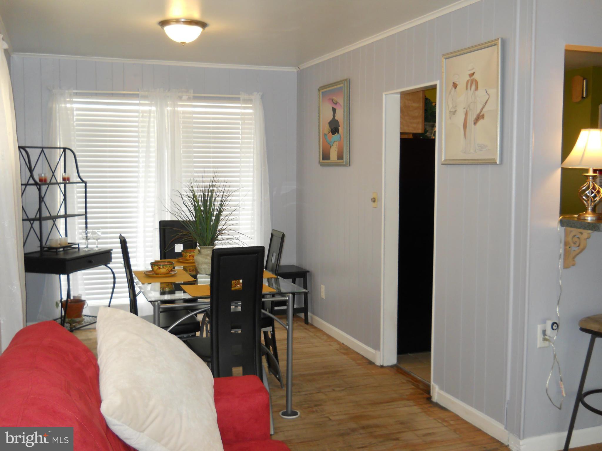 7411 Sudbrook Road Baltimore, MD 21208 - Photo 9 of 30 a view of a workspace with furniture and a window
