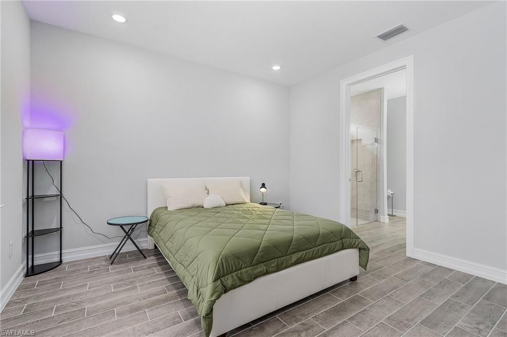 28367 Captiva Shell Loop Bonita Springs, FL 34135 - Photo 15 of 36 a bedroom with a bed and a lamp