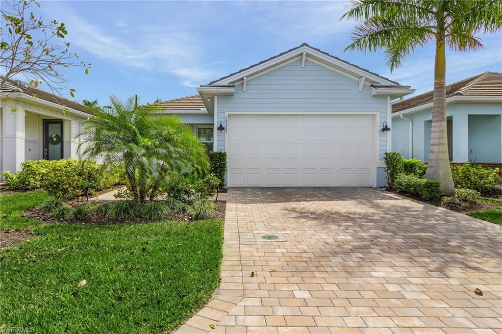 28367 Captiva Shell Loop Bonita Springs, FL 34135 - Photo 23 of 36 a front view of a house with a yard and garage