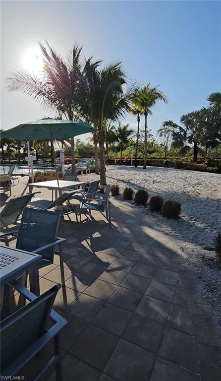 28367 Captiva Shell Loop Bonita Springs, FL 34135 - Photo 31 of 36 a view of swimming pool with outdoor seating and trees in the background