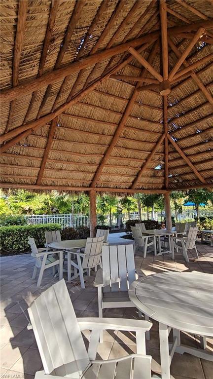 28367 Captiva Shell Loop Bonita Springs, FL 34135 - Photo 32 of 36 a view of a patio with table and chairs under an umbrella
