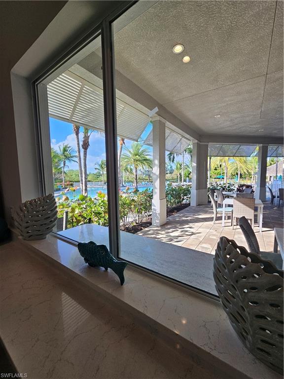 28367 Captiva Shell Loop Bonita Springs, FL 34135 - Photo 33 of 36 a room with pool table and glass windows