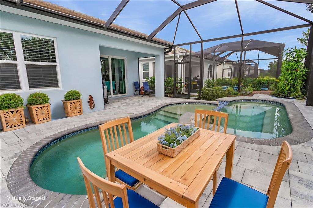 28367 Captiva Shell Loop Bonita Springs, FL 34135 - Photo 4 of 36 a view of a house with pool table and chairs under an umbrella